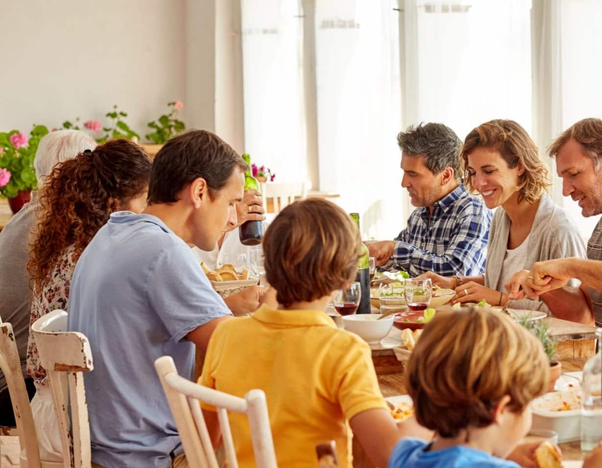 A group of friends laughing together over coffee or a family enjoying a meal