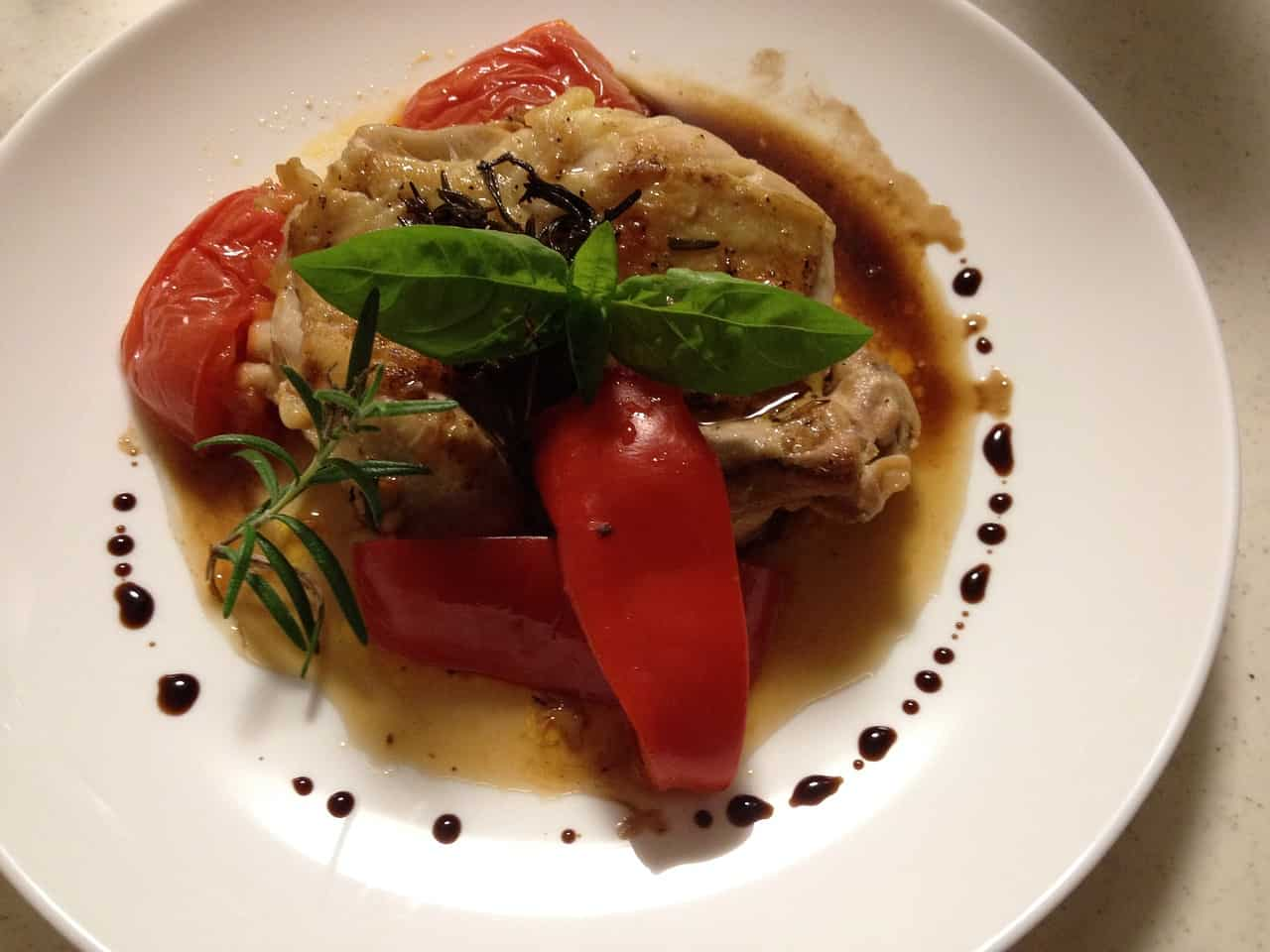 A plate of Caprese chicken with a drizzle of balsamic glaze