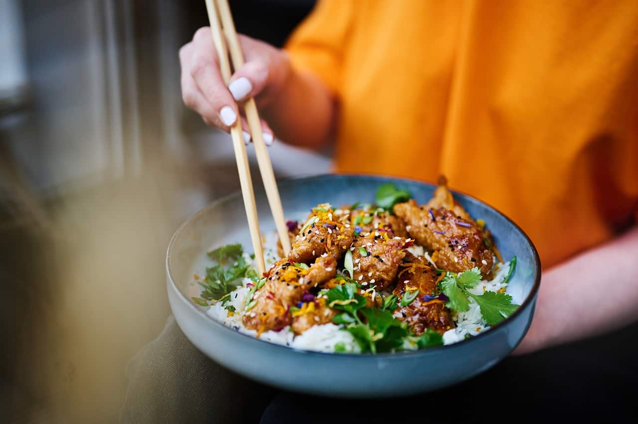 A vibrant stir-fry with chicken and vegetables served over rice